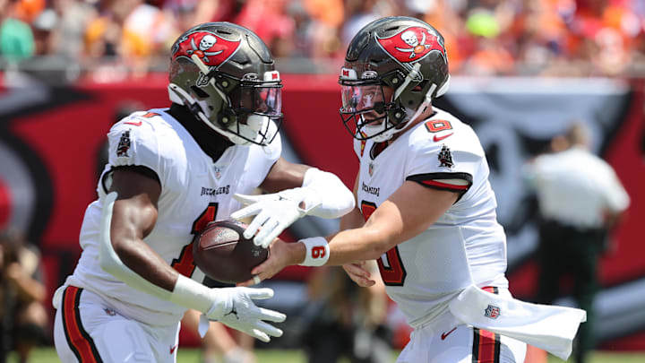 Sep 22, 2024; Tampa, Florida, USA;Tampa Bay Buccaneers quarterback Baker Mayfield (6) hands the ball off to running back Rachaad White (1) during the first quarter against the Denver Broncos at Raymond James Stadium. Mandatory Credit: Kim Klement Neitzel-Imagn Images