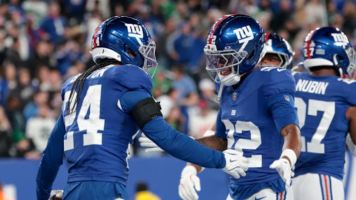 Oct 9, 2025; East Rutherford, New Jersey, USA; New York Giants safety Dane Belton (24) and cornerback Dru Phillips (22) celebrate after a fumble by the Philadelphia Eagles during the fourth quarter of the game at MetLife Stadium.  