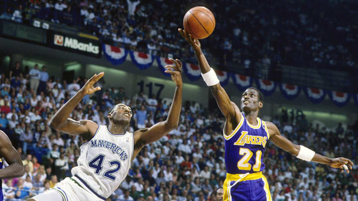 May 1988; Dallas, TX, USA; FILE PHOTO;  Los Angeles Lakers forward Michael Cooper (21) shoots over Dallas Mavericks forward Roy Tarpley (42) during the 1988 NBA Western Conference Finals at Reunion Arena. Mandatory Credit: MPS-Imagn Images