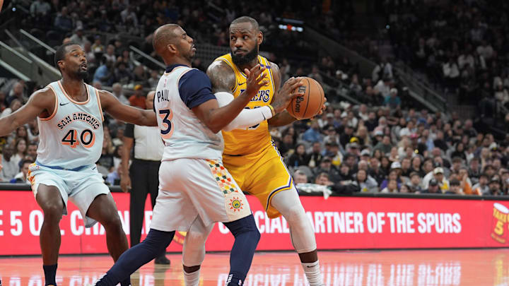 Nov 27, 2024; San Antonio, Texas, USA;  Los Angeles Lakers forward LeBron James (23) dribbles against San Antonio Spurs guard Chris Paul (3) in the second half at Frost Bank Center. Mandatory Credit: Daniel Dunn-Imagn Images