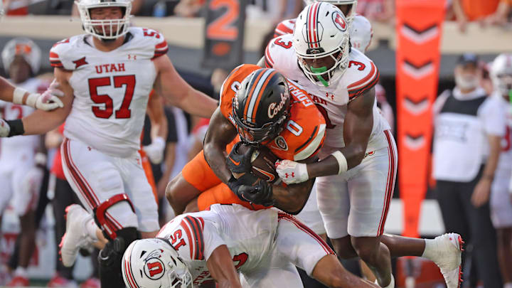 Oklahoma State's Ollie Gordon II (0) is tackled by the Utah defense in the second half of the college football between the Oklahoma State University Cowboys and the Utah Utes at Boone Pickens Stadium in Stillwater, Okla., Saturday, Sept., 21, 2024. Oklahoma State's Ollie Gordon II (0) is tackled by the Utah defense in the second half of the college football between the Oklahoma State University Cowboys and the Utah Utes at Boone Pickens Stadium in Stillwater, Okla., Saturday, Sept., 21, 2024.