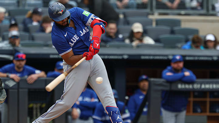 Apr 27, 2025; Bronx, New York, USA; Toronto Blue Jays first baseman Vladimir Guerrero Jr. (27) hits an RBI ground out during the first inning against the New York Yankees at Yankee Stadium.