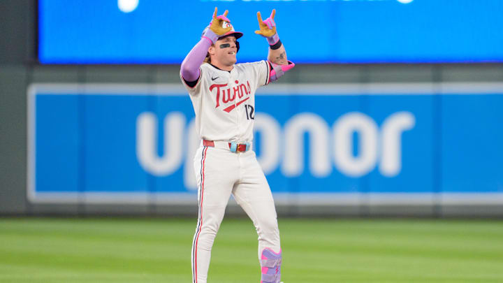 Jul 26, 2025; Minneapolis, Minnesota, USA; Minnesota Twins left fielder Harrison Bader (12) hits a ground rule double in the eighth inning off Washington Nationals pitcher Jackson Rutledge (79) at Target Field. Mandatory Credit: Matt Blewett-Imagn Images