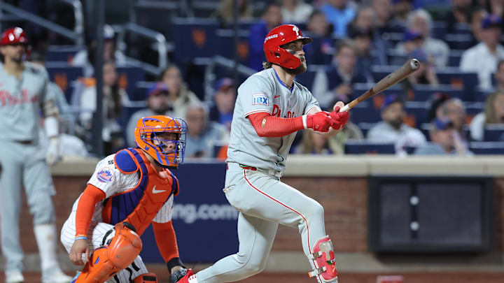 Oct 9, 2024; New York, New York, USA; Philadelphia Phillies first baseman Bryce Harper (3) hits a double in the sixth inning against the New York Mets in game four of the NLDS for the 2024 MLB Playoffs at Citi Field.
