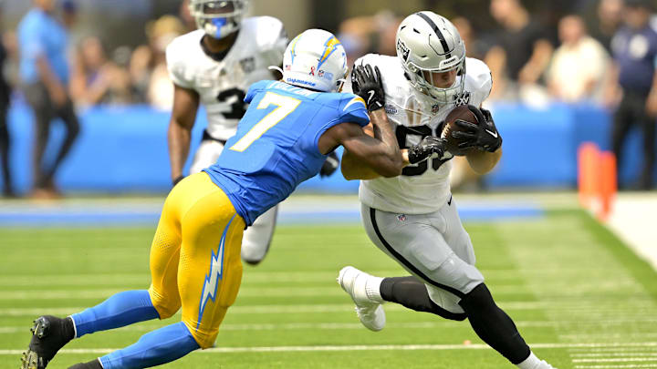 Sep 8, 2024; Inglewood, California, USA; Las Vegas Raiders tight end Brock Bowers (89) runs for a first down before he is stopped by Los Angeles Chargers cornerback Kristian Fulton (7) in the first half at SoFi Stadium. Mandatory Credit: Jayne Kamin-Oncea-Imagn Images