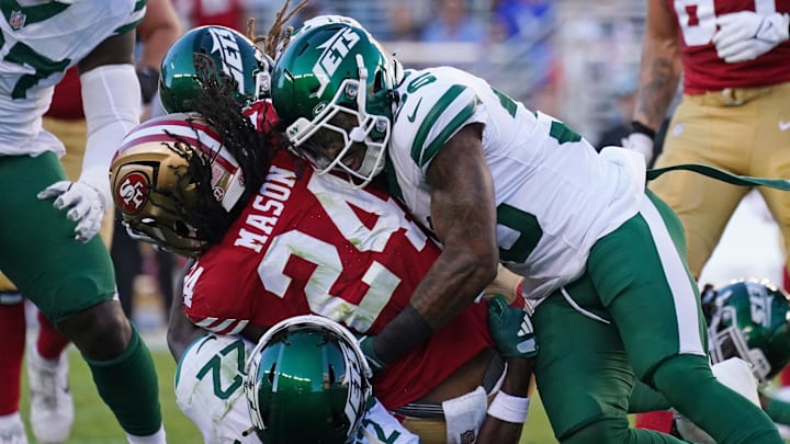 Sep 9, 2024; Santa Clara, California, USA; San Francisco 49ers running back Jordan Mason (24) is tackled by New York Jets safety Tony Adams (22) and New York Jets linebacker Quincy Williams (56) in the second quarter at Levi's Stadium. Sep 9, 2024; Santa Clara, California, USA; San Francisco 49ers running back Jordan Mason (24) is tackled by New York Jets safety Tony Adams (22) and New York Jets linebacker Quincy Williams (56) in the second quarter at Levi's Stadium.