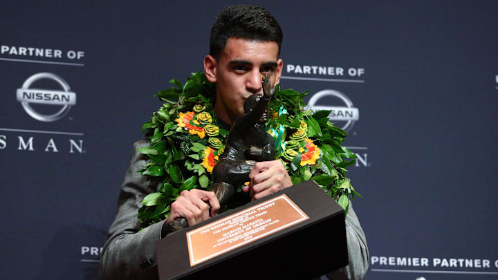 Dec 13, 2014; New York, NY, USA; Oregon Ducks quarterback Marcus Mariota kisses the Heisman Trophy during a press conference at the New York Marriott Marquis after winning the Heisman Trophy. Dec 13, 2014; New York, NY, USA; Oregon Ducks quarterback Marcus Mariota kisses the Heisman Trophy during a press conference at the New York Marriott Marquis after winning the Heisman Trophy.