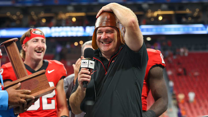 Georgia Bulldogs head coach Kirby Smart wears the old leather helmet after a victory over the Clemson Tigers