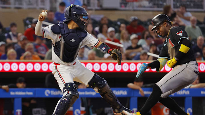 Sep 13, 2025; Minneapolis, Minnesota, USA; Minnesota Twins catcher Jhonny Pereda (65) forces out Arizona Diamondbacks shortstop Geraldo Perdomo (2) on a fielder's choice but fails to convert a double play in the fifth inning at Target Field. Mandatory Credit: Bruce Kluckhohn-Imagn Images