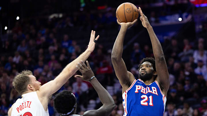 Nov 2, 2023; Philadelphia, Pennsylvania, USA; Philadelphia 76ers center Joel Embiid (21) shoots the ball past Toronto Raptors center Jakob Poeltl (19) and forward Pascal Siakam (43) during the second quarter at Wells Fargo Center. Mandatory Credit: Bill Streicher-Imagn Images