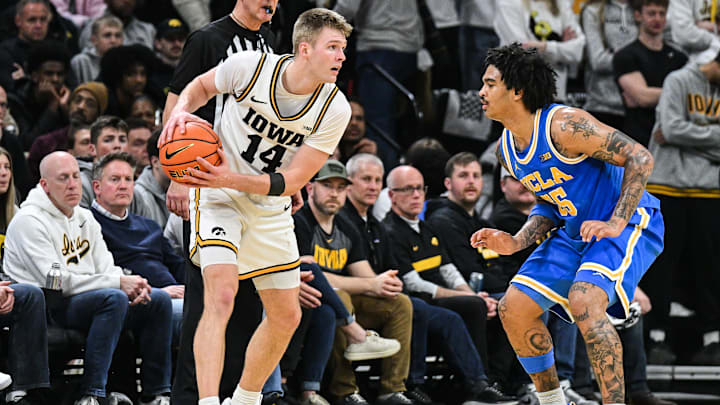 Jan 3, 2026; Iowa City, Iowa, USA; Iowa Hawkeyes guard Bennett Stirtz (14) is defended by UCLA Bruins guard Skyy Clark (55) during the first half at Carver-Hawkeye Arena. Mandatory Credit: Jeffrey Becker-Imagn Images