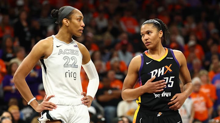 Oct 8, 2025; Phoenix, Arizona, USA; Las Vegas Aces center A'ja Wilson (22) and Phoenix Mercury forward Alyssa Thomas (25) talk during a time out in the second half during game three of the 2025 WNBA Finals at PHX Arena. Mandatory Credit: Mark J. Rebilas-Imagn Images
