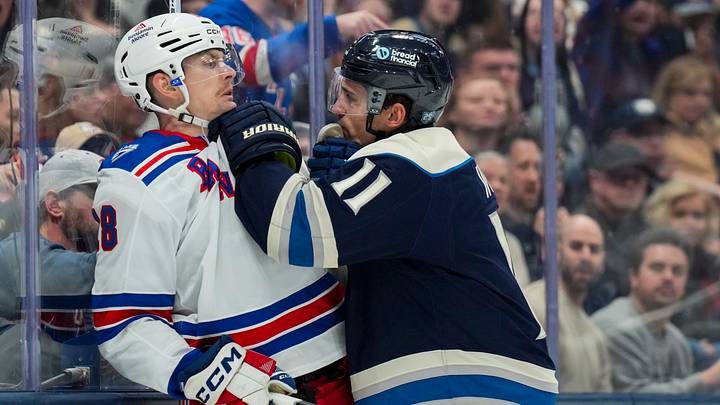 Nov 15, 2025; Columbus, Ohio, USA;  Columbus Blue Jackets left wing Miles Wood (11) scrums with New York Rangers defenseman Urho Vaakanainen (18) in the second period at Nationwide Arena. Mandatory Credit: Aaron Doster-Imagn Images