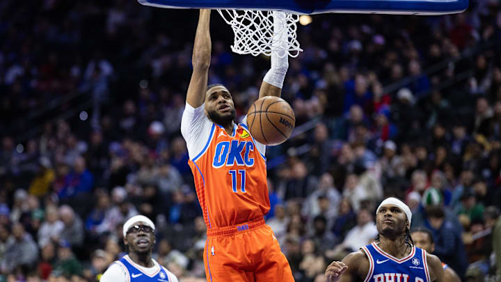 Jan 14, 2025; Philadelphia, Pennsylvania, USA; Oklahoma City Thunder guard Isaiah Joe (11) dunks in front of Philadelphia 76ers guard Ricky Council IV (14) during the second quarter at Wells Fargo Center. Mandatory Credit: Bill Streicher-Imagn Images