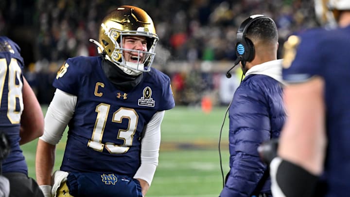 Dec 20, 2024; Notre Dame, Indiana, USA; Notre Dame Fighting Irish quarterback Riley Leonard (13) celebrates with head coach Marcus Freeman after scoring a touchdown during the second half against the Indiana Hoosiers at Notre Dame Stadium. Mandatory Credit: Matt Cashore-Imagn Images