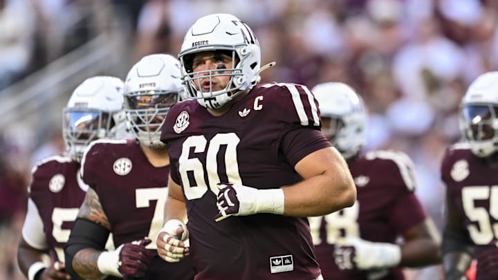 Oct 11, 2025; College Station, Texas, USA; Texas A&M Aggies offensive lineman Trey Zuhn III (60) and the offense runs onto the field in the first half against the Florida Gators at Kyle Field. Mandatory Credit: Maria Lysaker-Imagn Images 