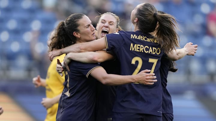 Jul 19, 2024; Seattle, WA, USA; Seattle Reign FC midfielder Olivia Athens (12) celebrates with teammates after scoring on a penalty kick during the first half against the Utah Royals FC at Lumen Field. Mandatory Credit: Stephen Brashear-USA TODAY Sports