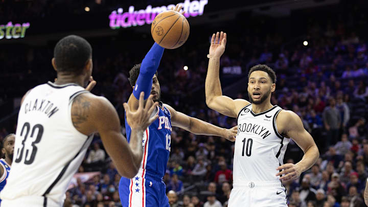 Nov 22, 2022; Philadelphia, Pennsylvania, USA; Brooklyn Nets guard Ben Simmons (10) passes the ball to forward Nic Claxton (33) past Philadelphia 76ers forward Tobias Harris (12) during the first quarter at Wells Fargo Center. Mandatory Credit: Bill Streicher-Imagn Images Nov 22, 2022; Philadelphia, Pennsylvania, USA; Brooklyn Nets guard Ben Simmons (10) passes the ball to forward Nic Claxton (33) past Philadelphia 76ers forward Tobias Harris (12) during the first quarter at Wells Fargo Center. Mandatory Credit: Bill Streicher-Imagn Images