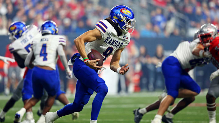 Dec 26, 2023; Phoenix, AZ, USA; Kansas Jayhawks quarterback Jason Bean (9) runs with the ball during the second half against the UNLV Rebels in the Guaranteed Rate Bowl at Chase Field. Mandatory Credit: Mark J. Rebilas-USA TODAY Sports