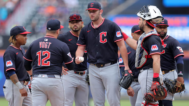 Aug 6, 2025; New York City, New York, USA; Cleveland Guardians manager Stephen Vogt (12) takes the ball from starting pitcher Gavin Williams (32) during a pitching change during the ninth inning against the New York Mets at Citi Field. Mandatory Credit: Brad Penner-Imagn Images