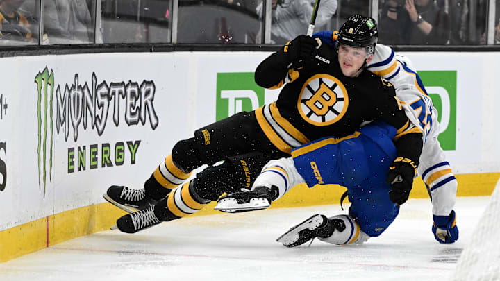 Apr 23, 2026; Boston, Massachusetts, USA; Boston Bruins defenseman Mason Lohrei (6) checks Buffalo Sabres center Tyson Kozak (48) during the second period of game three of the first round of the 2026 Stanley Cup Playoffs at the TD Garden. Mandatory Credit: Brian Fluharty-Imagn Images