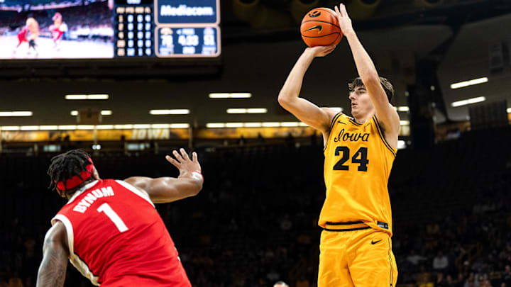 Iowa guard Tate Sage (24) shoots the basketball against Ohio State forward Amare Bynum (1) Feb. 25, 2026 at Carver-Hawkeye Arena in Iowa City, Iowa. Iowa guard Tate Sage (24) shoots the basketball against Ohio State forward Amare Bynum (1) Feb. 25, 2026 at Carver-Hawkeye Arena in Iowa City, Iowa.