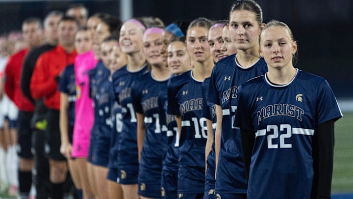 The Marist girl soccer team lines up for the Star Spangled Banner before their playoff match against Henley in Eugene Nov. 11, 2025.