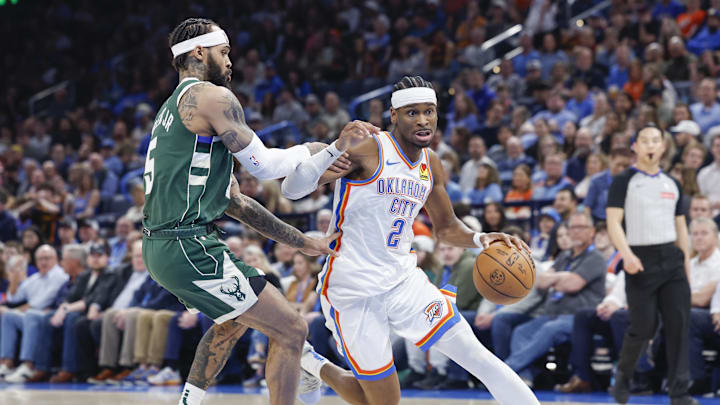 Feb 3, 2025; Oklahoma City, Oklahoma, USA; Oklahoma City Thunder guard Shai Gilgeous-Alexander (2) moves around Milwaukee Bucks guard Gary Trent Jr. (5) during the second half at Paycom Center. Mandatory Credit: Alonzo Adams-Imagn Images
