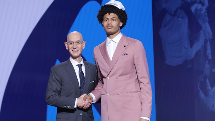Jun 25, 2025; Brooklyn, NY, USA;  Joan Beringer stands with NBA commissioner Adam Silver after being selected as the 17th pick by the Minnesota Timberwolves in the first round of the 2025 NBA Draft at Barclays Center.