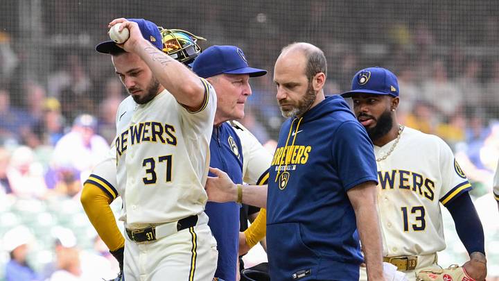 Jun 4, 2026; Milwaukee, Wisconsin, USA; Milwaukee Brewers pitcher DL Hall (37) leaves the game against the San Francisco Giants with athletic trainer Brad Epstein after an injury in the fifth inning at American Family Field. Mandatory Credit: Benny Sieu-Imagn Images