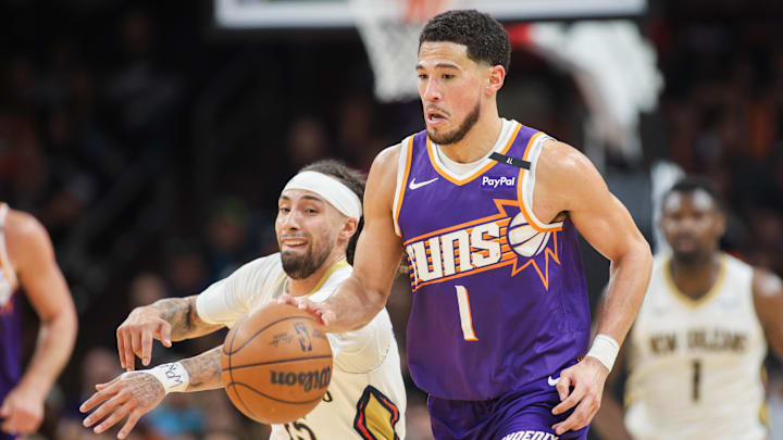 Feb 27, 2025; Phoenix, Arizona, USA; New Orleans Pelicans guard Jose Alvarado (15) steals the ball from Phoenix Suns guard Devin Booker (1) in the fourth quarter at Footprint Center. Mandatory Credit: Brett Davis-Imagn Images