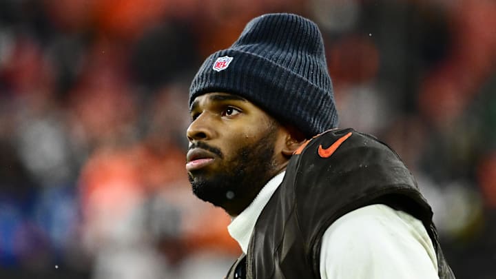 Dec 7, 2025; Cleveland, Ohio, USA; Cleveland Browns quarterback Shedeur Sanders (12) watches from the sidelines late in the fourth quarter against the Tennessee Titans at Huntington Bank Field. Mandatory Credit: Ken Blaze-Imagn Images
