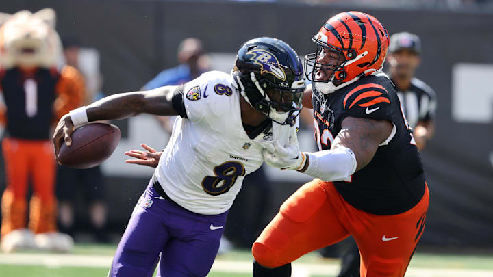 Baltimore Ravens quarterback Lamar Jackson (8) escapes the pressure from Cincinnati Bengals defensive tackle B.J. Hill (92) during the first half at Paycor Stadium. Baltimore Ravens quarterback Lamar Jackson (8) escapes the pressure from Cincinnati Bengals defensive tackle B.J. Hill (92) during the first half at Paycor Stadium.