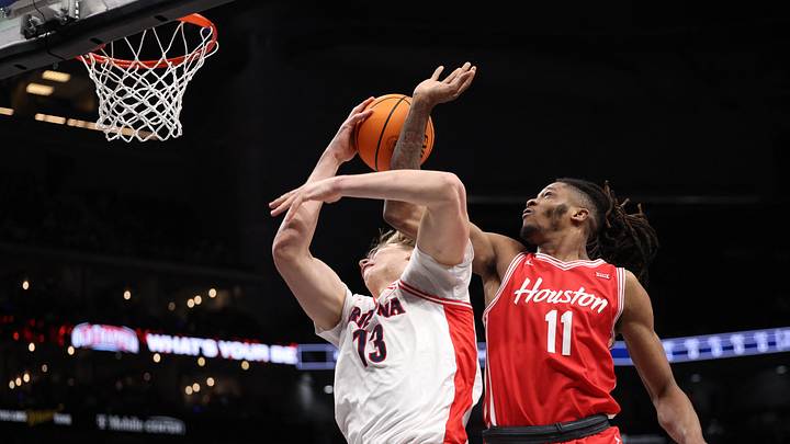 Mar 14, 2026; Kansas City, MO, USA; Houston Cougars forward Joseph Tugler (11) drives to the hoop past Arizona Wildcats center Motiejus Krivas (13) during the second half during the men's Big 12 Conference Tournament Championship at T-Mobile Center. Mar 14, 2026; Kansas City, MO, USA; Houston Cougars forward Joseph Tugler (11) drives to the hoop past Arizona Wildcats center Motiejus Krivas (13) during the second half during the men's Big 12 Conference Tournament Championship at T-Mobile Center.