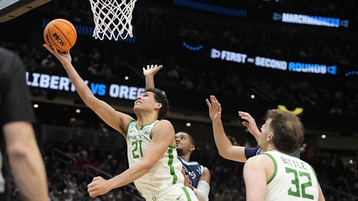 Mar 21, 2025; Seattle, WA, USA; Oregon Ducks forward Brandon Angel (21) shoots the ball against the Liberty Flames during the first half in the first round of the NCAA Tournament  at Climate Pledge Arena. Mandatory Credit: Stephen Brashear-Imagn Images