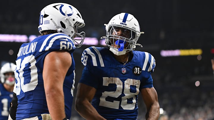 Oct 26, 2025; Indianapolis, Indiana, USA; Indianapolis Colts running back Jonathan Taylor (28) celebrates with Indianapolis Colts center Tanor Bortolini (60) after scoring a touchdown during the third quarter against the Tennessee Titans at Lucas Oil Stadium. 