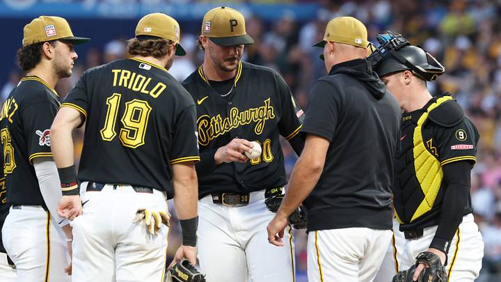 Jul 25, 2026; Pittsburgh, Pennsylvania, USA; Pittsburgh Pirates starting pitcher Paul Skenes (middle) surrenders the ball to manager Don Kelly (12) while being removed from the game during the sixth inning against the Chicago Cubs at PNC Park. Mandatory Credit: Charles LeClaire-Imagn Images