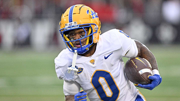 Nov 23, 2024; Louisville, Kentucky, USA;  Pittsburgh Panthers running back Desmond Reid (0) runs against the Louisville Cardinals during the first quarter at L&N Federal Credit Union Stadium. Mandatory Credit: Jamie Rhodes-Imagn Images