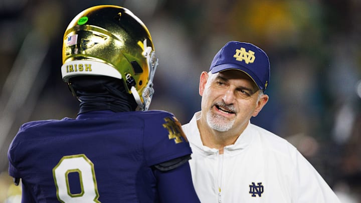 Notre Dame offensive line coach Joe Rudolph speaks with Notre Dame quarterback Kenny Minchey (8) before a NCAA college football game against Florida State at Notre Dame Stadium on Saturday, Nov. 9, 2024, in South Bend. Notre Dame offensive line coach Joe Rudolph speaks with Notre Dame quarterback Kenny Minchey (8) before a NCAA college football game against Florida State at Notre Dame Stadium on Saturday, Nov. 9, 2024, in South Bend.