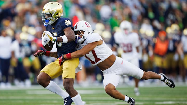 Stanford cornerback Jshawn Frausto-Ramos (17) tackles Notre Dame wide receiver Beaux Collins (5) during a NCAA college football game between Notre Dame and Stanford at Notre Dame Stadium on Saturday, Oct. 12, 2024, in South Bend