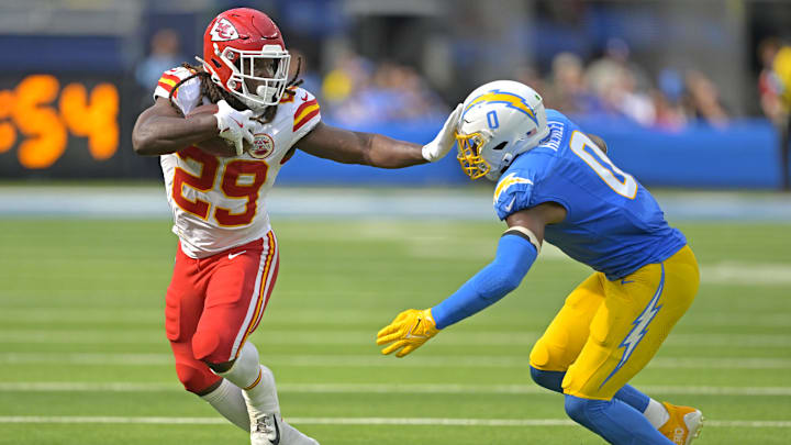 Sep 29, 2024; Inglewood, California, USA;  Kansas City Chiefs running back Kareem Hunt (29) runs for a first down before he is forced out of bounds by Los Angeles Chargers linebacker Daiyan Henley (0) in the second half at SoFi Stadium. Mandatory Credit: Jayne Kamin-Oncea-Imagn Images