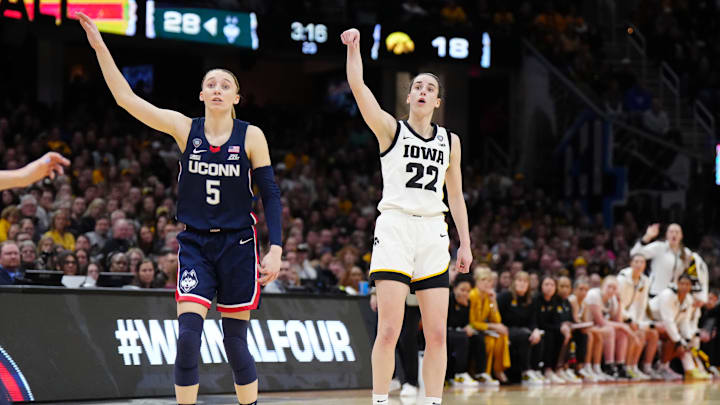 Apr 5, 2024; Cleveland, OH, USA; Iowa Hawkeyes guard Caitlin Clark (22) and Connecticut Huskies guard Paige Bueckers (5) react in the second quarter in the semifinals of the Final Four of the womens 2024 NCAA Tournament at Rocket Mortgage FieldHouse. Mandatory Credit: Kirby Lee-Imagn Images Apr 5, 2024; Cleveland, OH, USA; Iowa Hawkeyes guard Caitlin Clark (22) and Connecticut Huskies guard Paige Bueckers (5) react in the second quarter in the semifinals of the Final Four of the womens 2024 NCAA Tournament at Rocket Mortgage FieldHouse. Mandatory Credit: Kirby Lee-Imagn Images