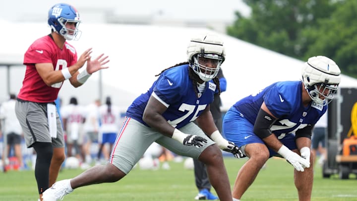 Jul 25, 2024; East Rutherford, NY, USA; New York Giants offensive tackle Joshua Ezeudu (75) participates in a drill during training camp at Quest Diagnostics Training Center.  