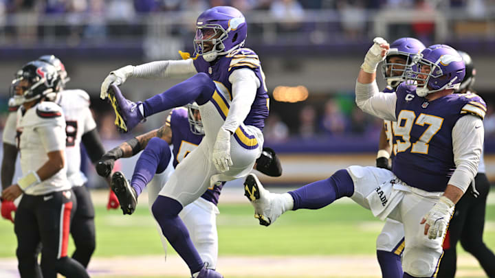 Sep 22, 2024; Minneapolis, Minnesota, USA; Minnesota Vikings linebacker Jonathan Greenard (58) and defensive tackle Harrison Phillips (97) react after a sack against the Houston Texans during the fourth quarter at U.S. Bank Stadium.
