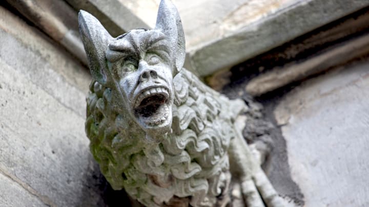 A freaky downspout carved in the form of a gargoyle on the Church of Saint Severin in Paris, France.