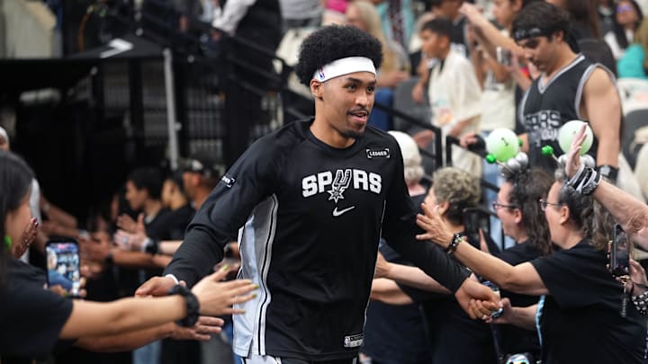 Apr 12, 2026; San Antonio, Texas, USA; San Antonio Spurs guard Dylan Harper (2) greets fans while entering the court before a game against the Denver Nuggets at Frost Bank Center. Mandatory Credit: Scott Wachter-Imagn Images