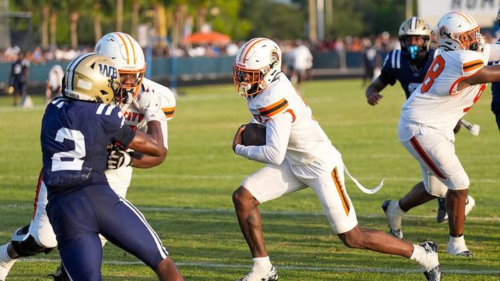 Carol City's Za'Kari Johnson (center), a Florida State commit, plays in a preseason Kickoff Classic game against West Boca Raton on Friday, Aug. 14, 2026 in Boca Raton.