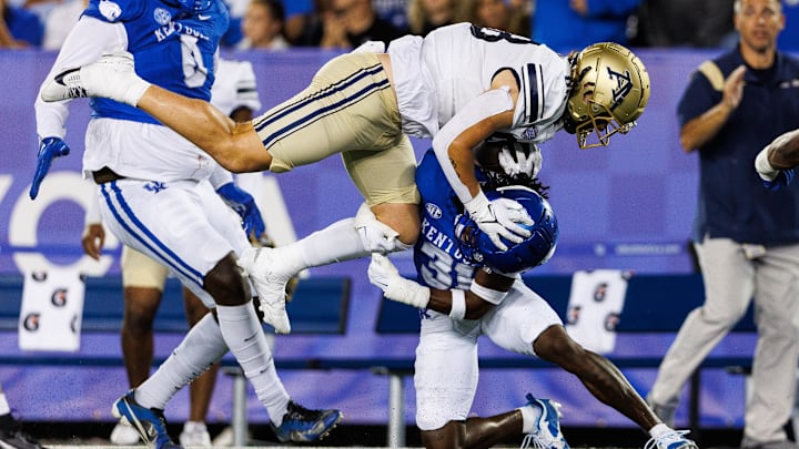 Sep 16, 2023; Lexington, Kentucky, USA; Akron Zips tight end Jake Newell (88) is stopped by Kentucky Wildcats defensive back Maxwell Hairston (31) during the third quarter at Kroger Field. 