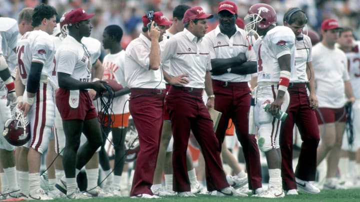 Arkansas Razorbacks head coach Ken Hatfield talks to quarterback Quinn Grovey during an upset bid against Jimmy Johnson's No. 1 Miami Hurricanes in Coral Gables on national television.
