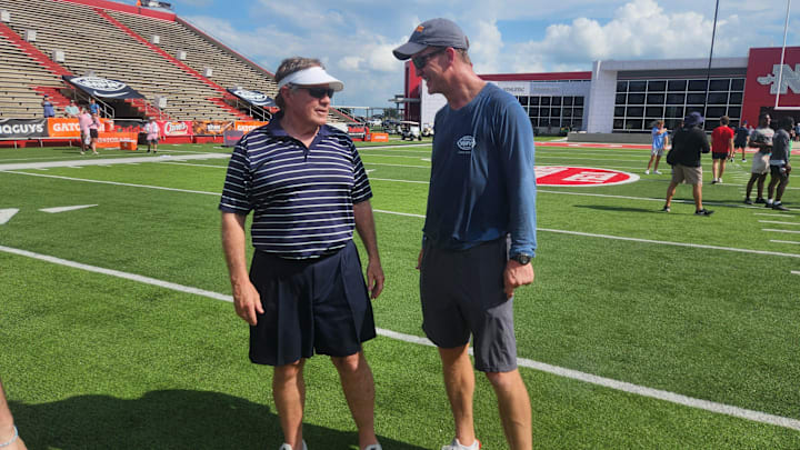 Legendary former NFL coach Bill Belichick talks with Peyton Manning at the 2024 Manning Passing Academy.